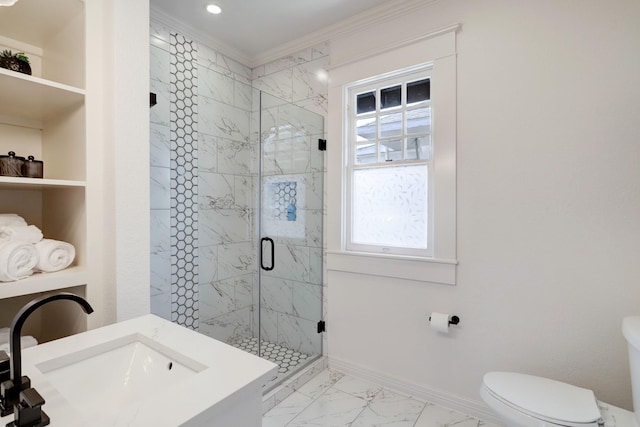 bathroom with crown molding, sink, a shower with door, and toilet