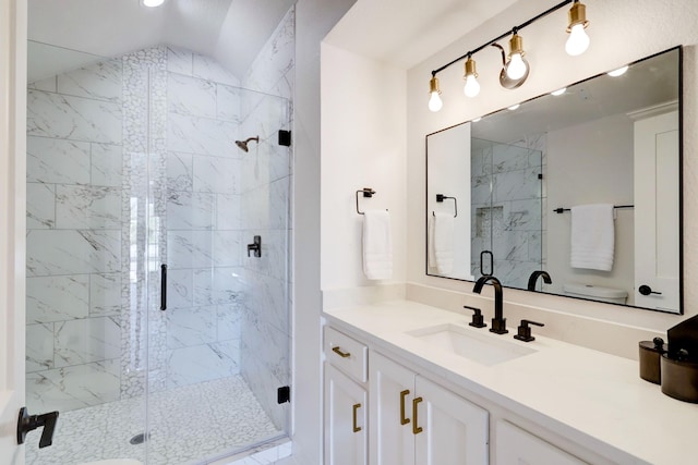 bathroom with vanity, walk in shower, and lofted ceiling