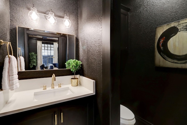 bathroom featuring toilet and vanity