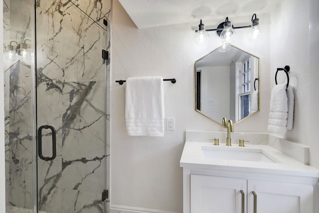 bathroom featuring a textured ceiling, vanity, and a shower with door