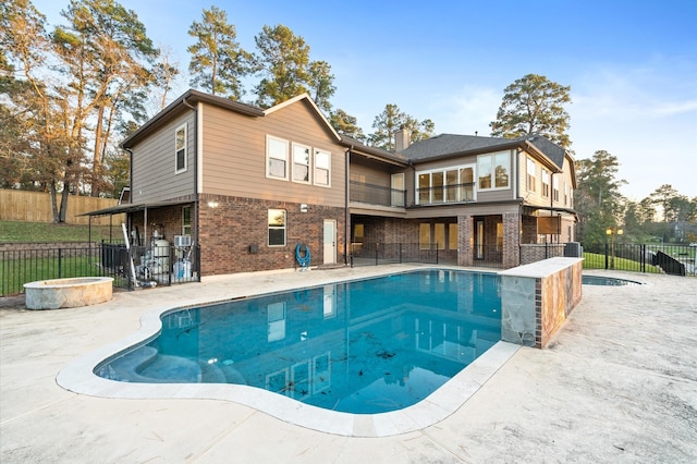 view of pool with a jacuzzi and a patio