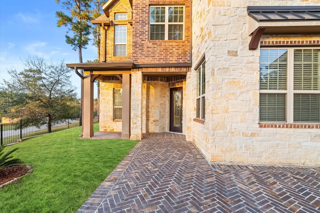 doorway to property with a yard