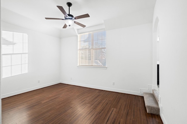 unfurnished room with dark hardwood / wood-style floors and ceiling fan