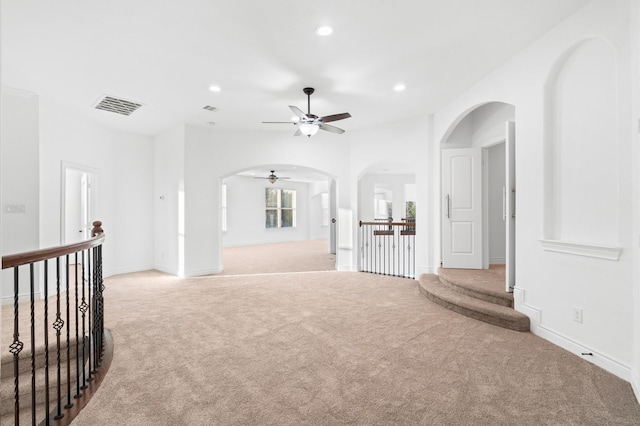 carpeted spare room with ceiling fan