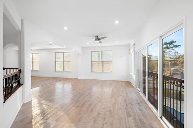 unfurnished living room featuring light hardwood / wood-style flooring, ceiling fan, and a healthy amount of sunlight