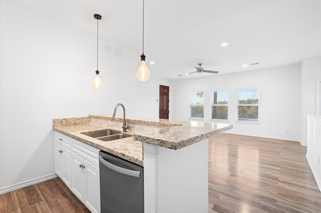 kitchen with light stone countertops, stainless steel dishwasher, sink, white cabinetry, and hanging light fixtures