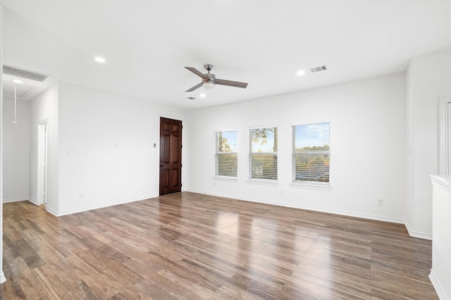 empty room featuring ceiling fan and hardwood / wood-style flooring