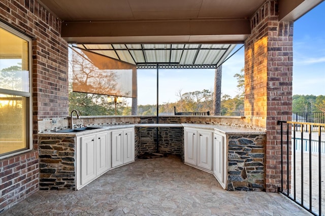 view of patio with an outdoor kitchen and sink