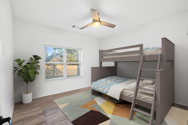 bedroom with wood-type flooring and ceiling fan