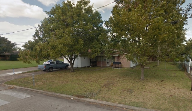 obstructed view of property with a front yard