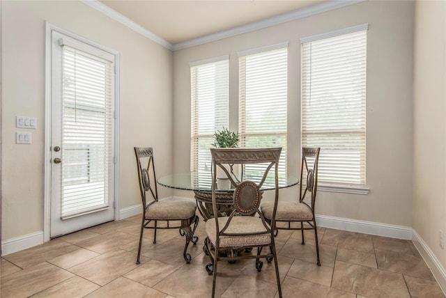 dining space with plenty of natural light, light tile patterned floors, and ornamental molding