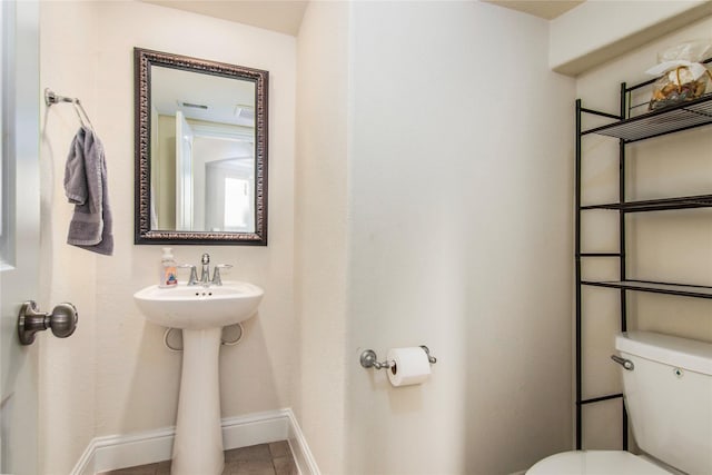 bathroom with tile patterned floors, toilet, and sink