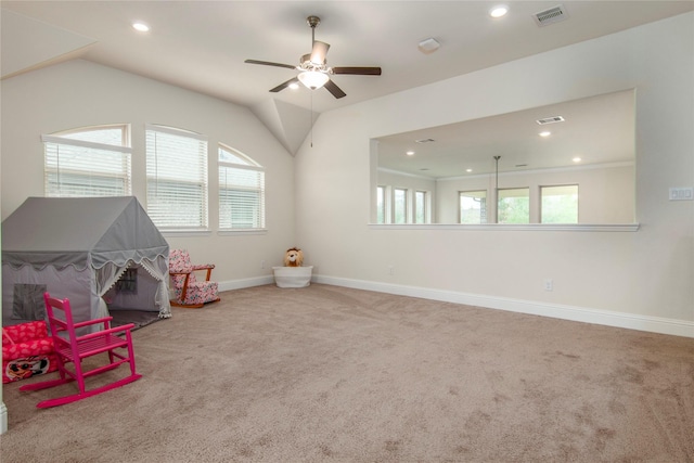 recreation room with carpet, ceiling fan, and vaulted ceiling