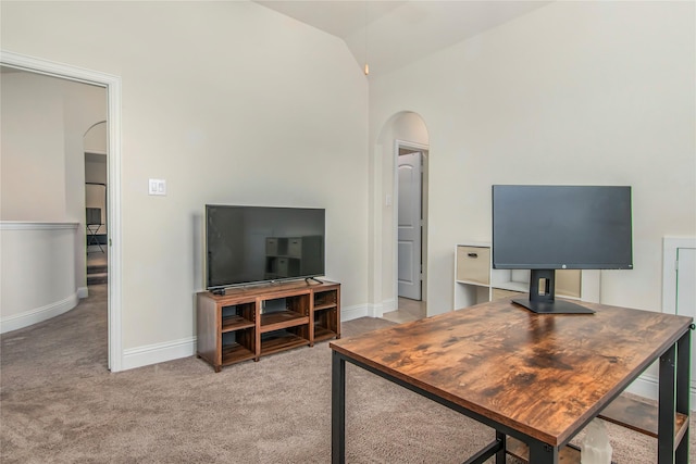 carpeted office space with lofted ceiling