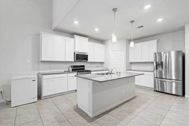 kitchen featuring white cabinets, appliances with stainless steel finishes, a center island with sink, and sink