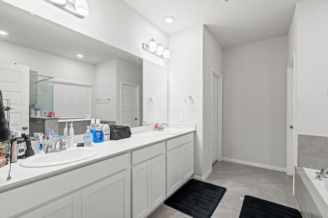 bathroom featuring tile patterned flooring, vanity, and a relaxing tiled tub