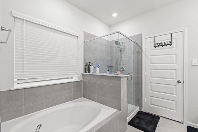 bathroom with tile patterned floors and separate shower and tub