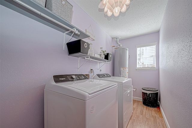 laundry room with independent washer and dryer, a textured ceiling, gas water heater, and light hardwood / wood-style flooring