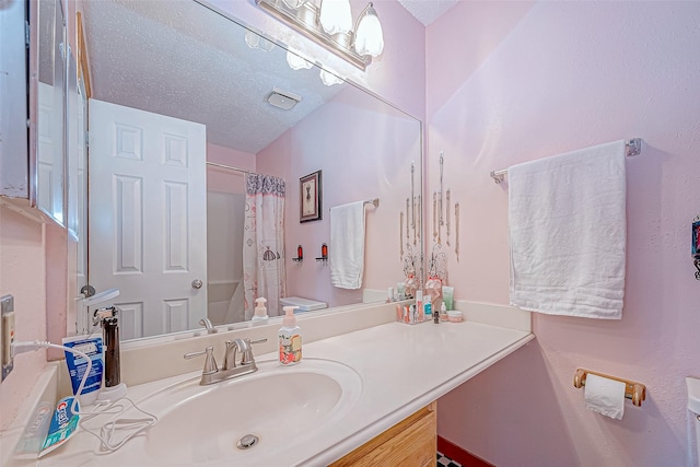 full bathroom with vanity, a textured ceiling, toilet, and shower / tub combo with curtain