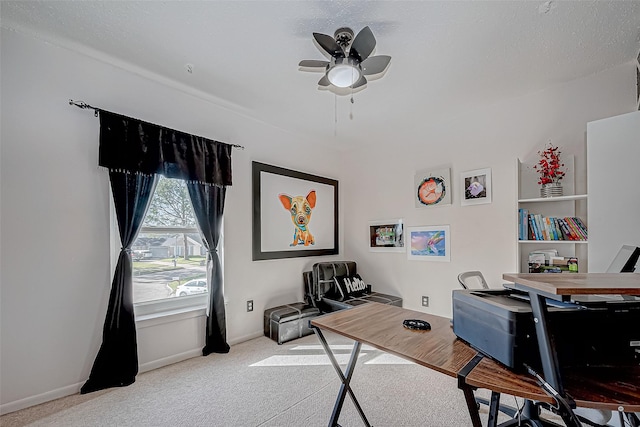 home office featuring a textured ceiling, carpet floors, and ceiling fan