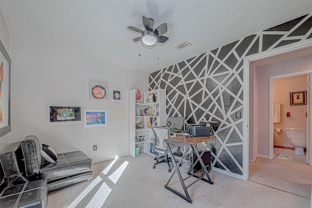 carpeted home office featuring ceiling fan and a textured ceiling