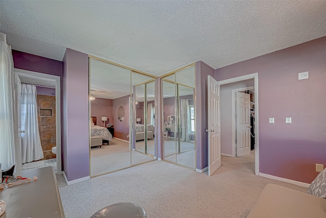 unfurnished bedroom featuring light colored carpet and a textured ceiling