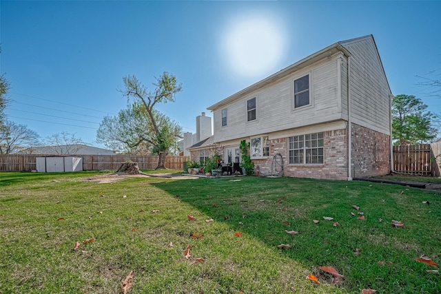 back of property featuring a storage shed and a yard