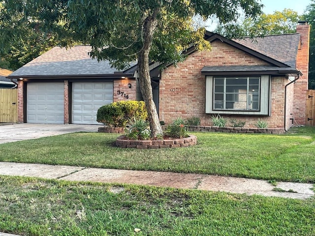 single story home featuring a front yard and a garage