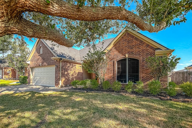 view of front of house with a front yard and a garage