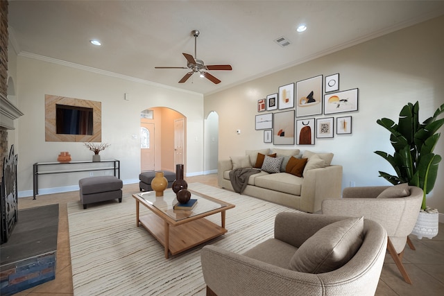 tiled living room featuring crown molding and ceiling fan