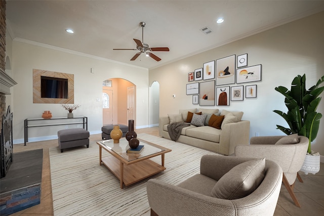 3815 Founders Dr, Needville, TX 77461 - living room with arched walkways, ceiling fan, tile patterned flooring, a fireplace with raised hearth, and recessed lighting