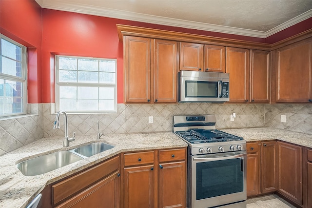 3815 Founders Dr, Needville, TX 77461 - kitchen with appliances with stainless steel finishes, brown cabinetry, crown molding, light stone counters, and decorative backsplash