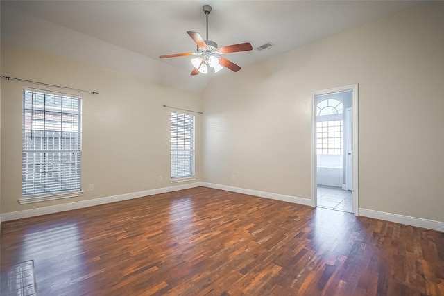 empty room featuring ceiling fan, dark hardwood / wood-style floors, and lofted ceiling