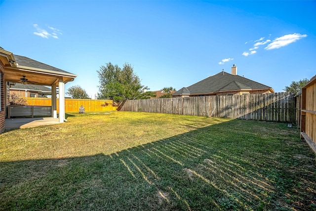 3815 Founders Dr, Needville, TX 77461 - fenced backyard featuring ceiling fan and a patio