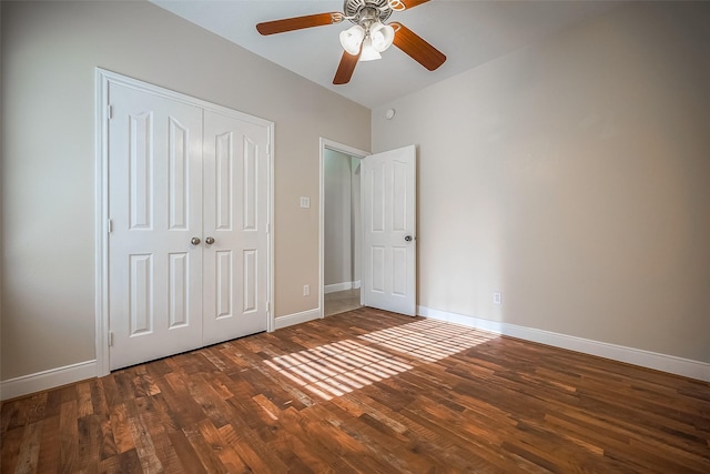 unfurnished bedroom featuring ceiling fan, dark hardwood / wood-style floors, and a closet