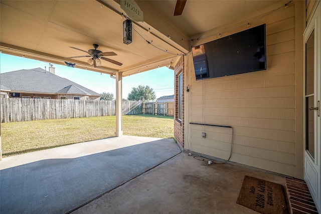 3815 Founders Dr, Needville, TX 77461 - fenced backyard with a ceiling fan and a patio area