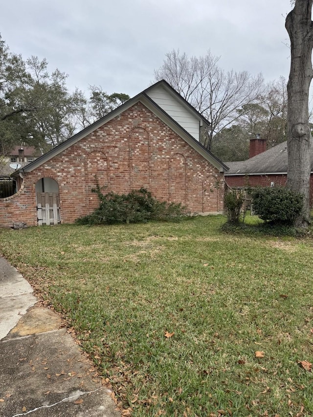 view of side of property with a yard