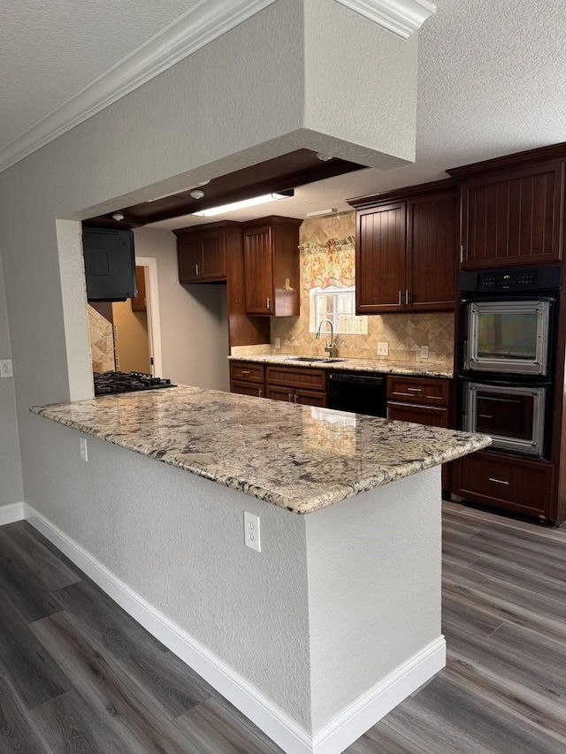 kitchen featuring crown molding, sink, light stone countertops, and a textured ceiling