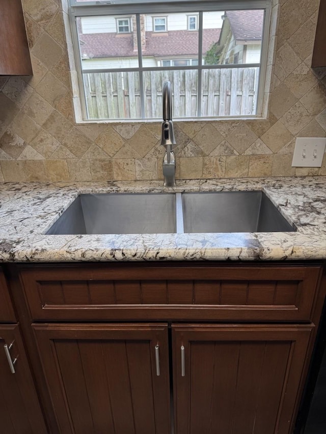 details with light stone countertops and sink