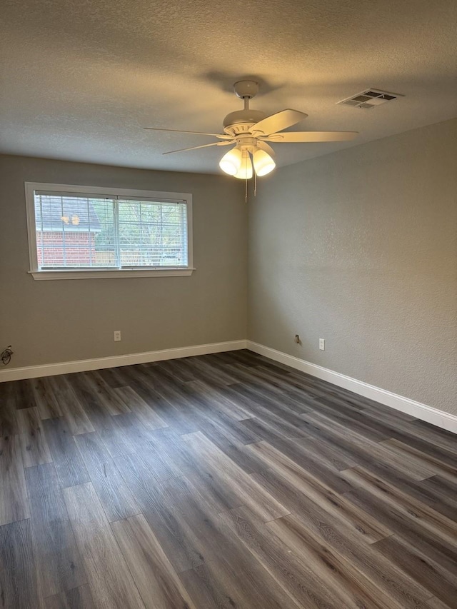 empty room featuring a textured ceiling, ceiling fan, and dark hardwood / wood-style floors