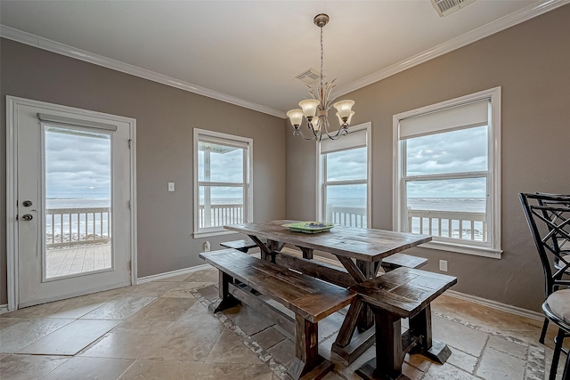 dining area with a chandelier, a water view, and crown molding