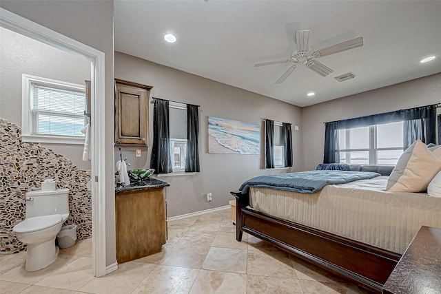 bedroom with ceiling fan and multiple windows