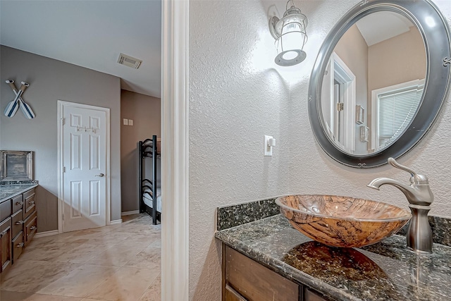 bathroom with vanity and tile patterned floors