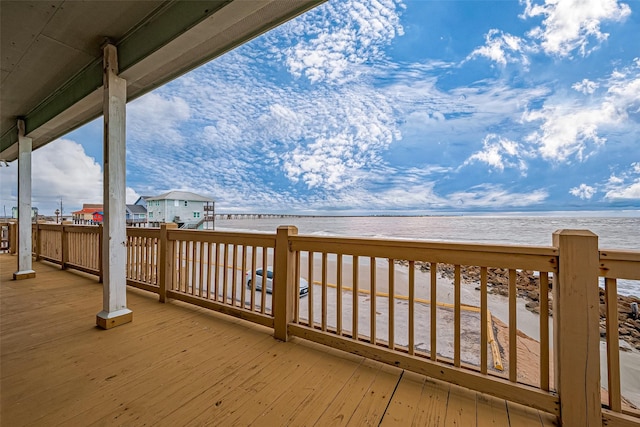 wooden terrace with a beach view and a water view