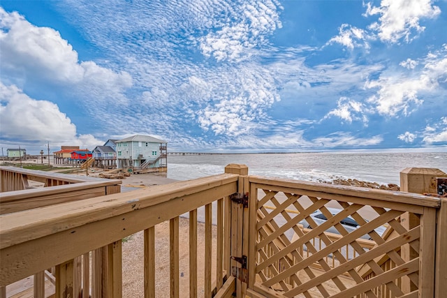 view of property's community with a water view and a beach view