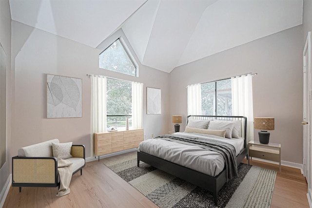 bedroom with light hardwood / wood-style flooring and vaulted ceiling