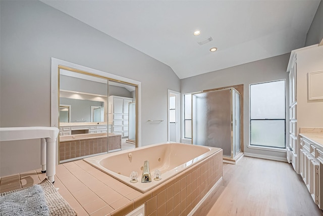 bathroom with vanity, wood-type flooring, lofted ceiling, and shower with separate bathtub