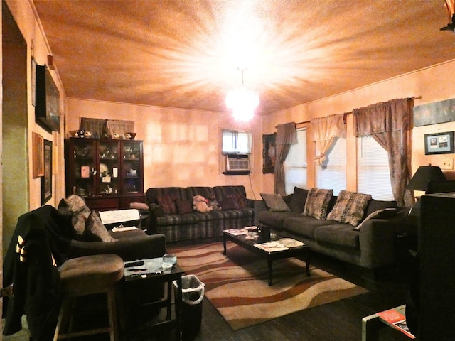 living room featuring a notable chandelier and cooling unit