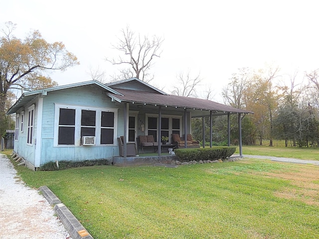 view of front facade with cooling unit, a front lawn, and covered porch