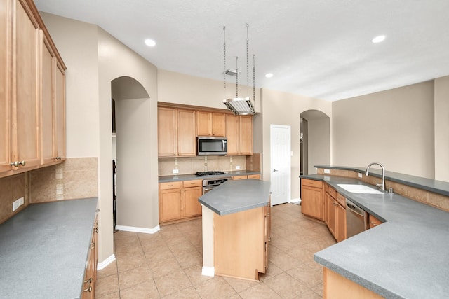 kitchen featuring sink, light brown cabinetry, tasteful backsplash, a kitchen island, and stainless steel appliances